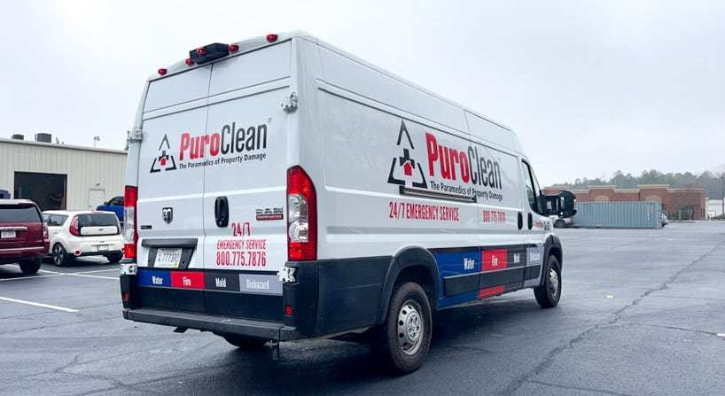 Partial vehicle wrap with cut logo and services for PuroClean van in Greenville, SC