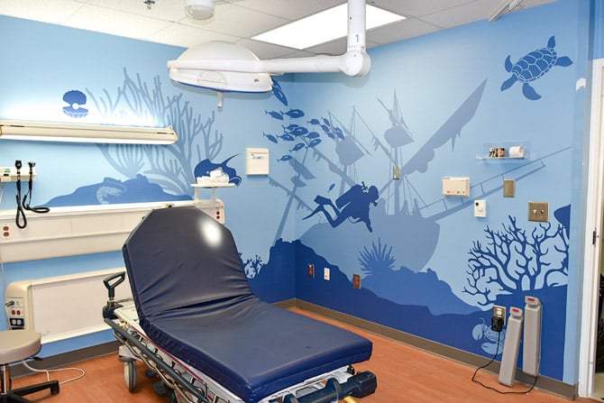 Hospital room wall wrap featuring an undersea theme of blue ocean related silhouettes at Prisma