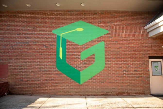 Large vinyl logo mural on brick at Green Charter Elementary School in Greenville, SC