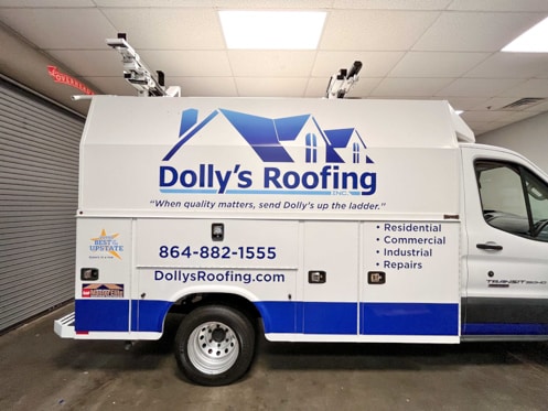 Logo, contact info and services on a roofing fleet vehicle.