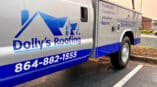 Logo, contact info and services on a roofing fleet's service truck.