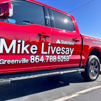 Black and white vinyl lettering for a local State Farm Agent on his red truck
