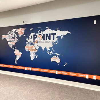 Custom wall mural showcasing global locations and company values for Point Global Logistics in Houston, TX