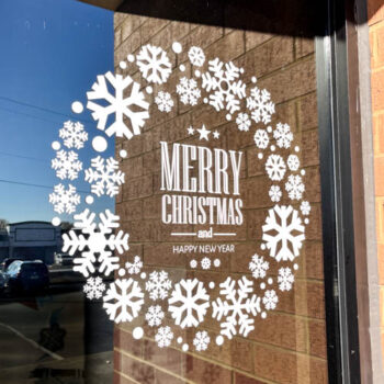 Die-cut holiday window graphics on the SpeedPro Greenville storefront