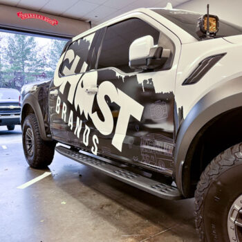 Custom partial black and white vehicle wrap showcasing Ghost Brand's creativity and branding
