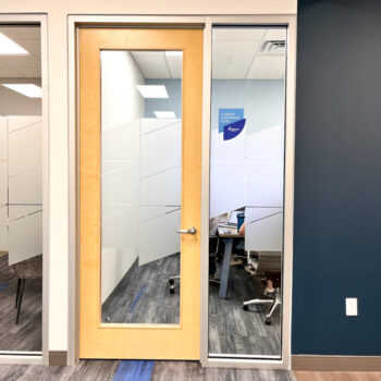 Custom cut frosted window film and vinyl room name on glass windows inside office at Ingenics Corporation in Greenville, SC