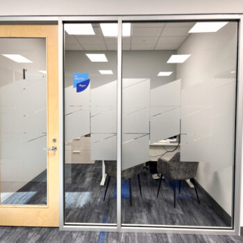 Custom cut frosted window film and vinyl room name on glass windows inside office at Ingenics Corporation in Greenville, SC