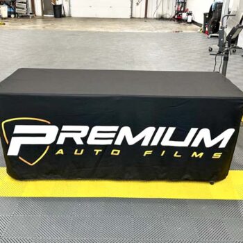 Custom fitted table throw with logo on a black background for Premium Auto Films in Greenville, SC