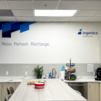 Wall decals including geometric pattern, logo and inspirational text on wall in office kitchen at Ingenics Corporation in Greenville, SC