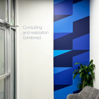 Custom geometric wall mural and cut vinyl quote in lobby at Ingenics Corporation in Greenville, SC