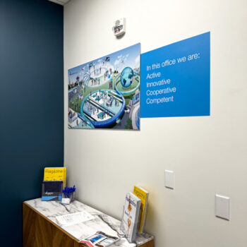 Ultraboard with printed graphic next to wall decal on lobby wall at Ingenics Corporation in Greenville, SC