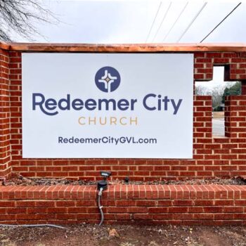 Monument sign temporarily refaced with vinyl installed on aluminum panels at Redeemer City Church in Greenville, SC