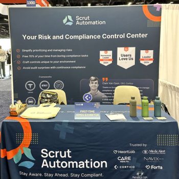 Cohesive table throw and backdrop display for Scrut Automation's tradeshow booth