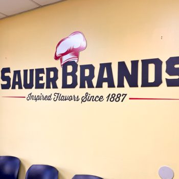 Ultraboard logo and vinyl tagline on wall inside Sauer Brand's lobby in Greenville, SC