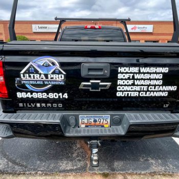 Custom cut decals on tailgate of pressure washing truck in Greenville, SC