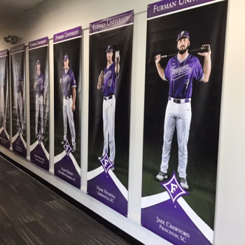 Hallway lined with senior banners for a Furman baseball team.