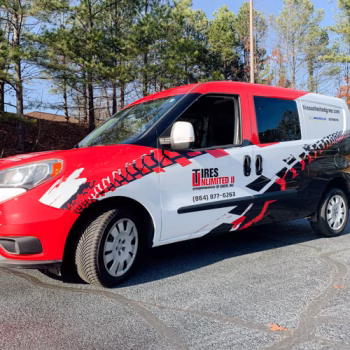 Full red and black tire themed wrap on a van for Tires Unlimited II's fleet in Greer, SC.