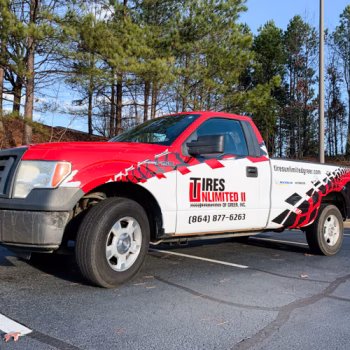 Full red and black tire themed wrap on a truck for Tires Unlimited II's fleet in Greer, SC.