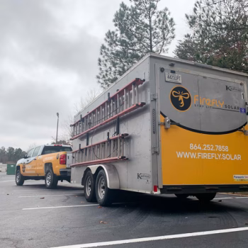 Yellow partial wrap on the back of a trailer and truck in Firefly Solar's fleet.