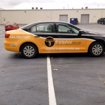Yellow partial wrap across a sedan in Firefly Solar's fleet.