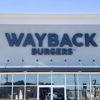 Wayback Burgers storefront sign with bold letters and a black vinyl face that turns white when lit.