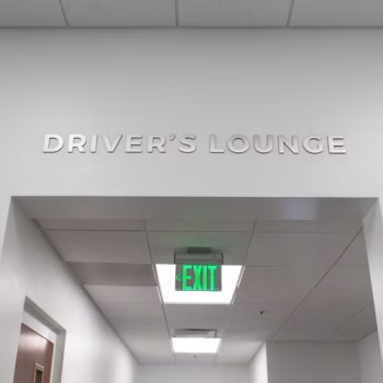 Brushed aluminum dimensional lettering directing to the driver's lounge at The Pete Store in Columbia, SC.