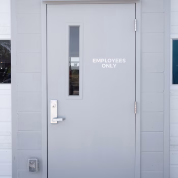 Employees Only vinyl on an exterior warehouse door at Peterbilt for Columbia, SC.