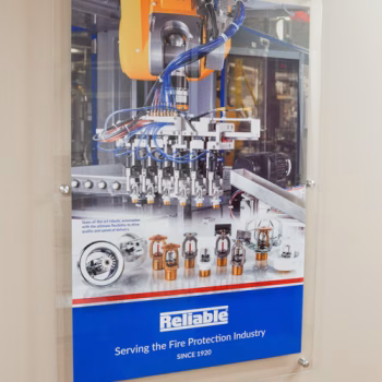 Acrylic display installed with standoffs displaying an image of new technology Reliable offers.