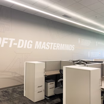 Large wall mural with neutral colors and company timeline in the shared office space at Vermeer's Piedmont, SC facility.