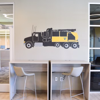 Small Vermeer truck wall decal above two desks in the waiting area of Vermeer's Piedmont, SC facility.