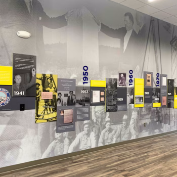 The 1950-1980 section of Blue Ridge Electric Co-Op's timeline display fabricated with wall murals, dimensional numbers, ultraboard prints and pvc prints displayed in Westminister, SC.