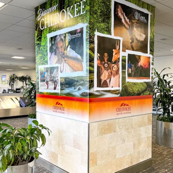 Column advertisements with a river background and Cherokee attraction images at the GSP International Airport.