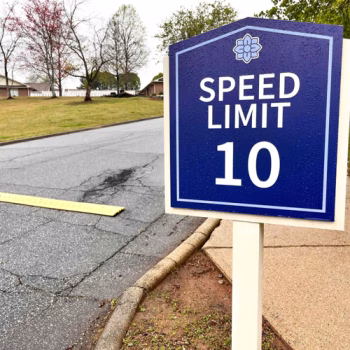 Serenity Apartments speed limit sign produced with printed ACM applied to existing sign posts.