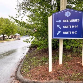 Serenity Apartments exterior directional signage produced with printed ACM applied to existing sign posts