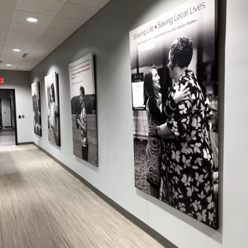 Custom gallery wrapped canvas displays with customer testimonals lining a hallway at The Blood Connection on Woodruff Road in Greenville, SC