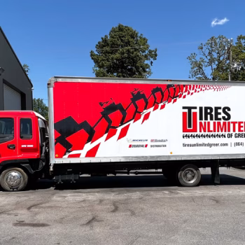 Full red, white and black box and cab wrap for large box truck in Tires Unlimited II's fleet in Greer, SC.