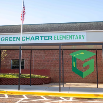Large G logo mural on brick and acm logo sign on exterior of Green Charter Elementary School in Greenville, SC