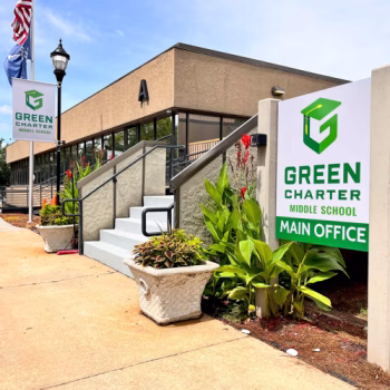 Branded pole banners and an exterior directional sign displaying 