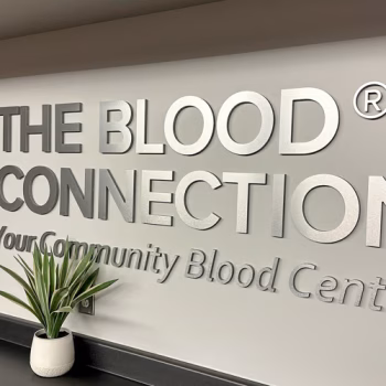 Brushed aluminum dimensional lettering of the Blood Connection logo in the conference room at The Blood Connection office in Piedmont, SC