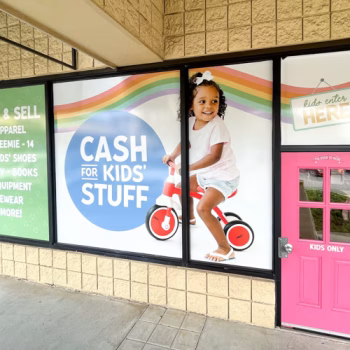 Window graphics showcasing brand's child-friendly atmosphere on storefront windows at Kid 2 Kid in Greenville, SC