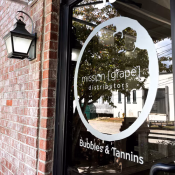 Frosted logo decals on a storefront door for Mission Grape in Greenville, SC