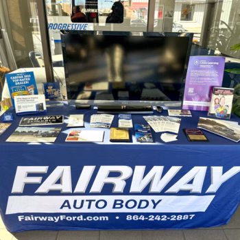 Fitted table throw with logo on a blue background for Fairway Ford's Auto Body Shop in Greenville, SC.