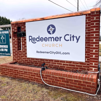 Monument sign temporarily refaced with vinyl installed on aluminum panels at Redeemer City Church in Greenville, SC.