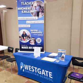 Custom table throw and retractable banner for a Christian school in Spartanburg's event booth.