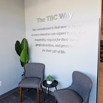 Brushed aluminum, dimensional lettering spelling out The Blood Connection's commitment statement in the Wake Forest, NC donation center.