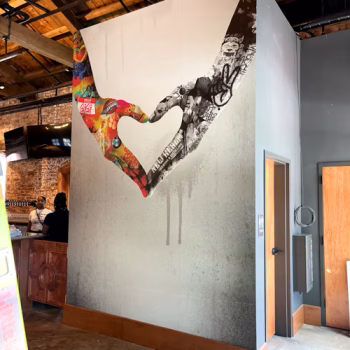 Creative wall mural with two hands forming a heart in a brewery in down town Greenville, SC.