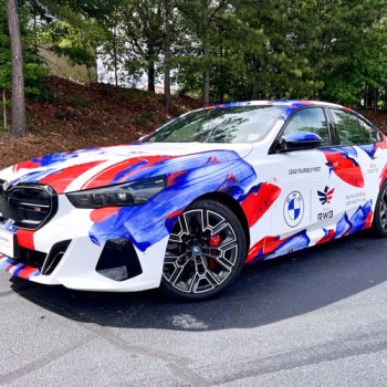 Custom full wrap on BMW with a paintstroke pattern on a white background for a lead car in a veterans race.