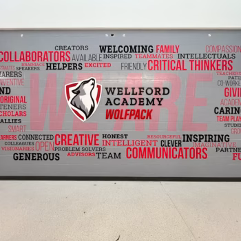 Custom word cloud wall mural with the Wellford Academy Wolfpack logo in dimensional acrylic in Wellford, SC.