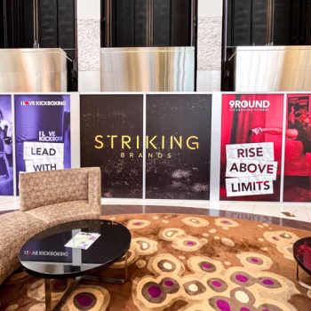 Temporary window graphics near a seating area at the 2024 Striking Brands convention.