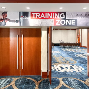 Temporary wall vinyl installed over doors leading to a workshop room at the 2024 Striking Brands convention.